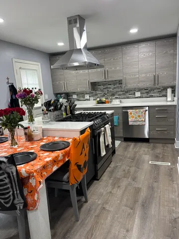 a kitchen with stainless steel appliances granite countertop a stove a sink and a refrigerator