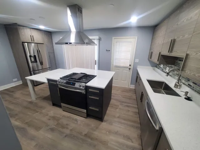 a kitchen with a stove and a refrigerator