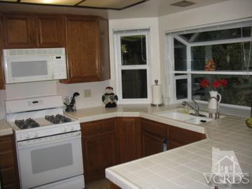 13670 Laurelhurst Road Moorpark, CA 93021 - Photo 5 of 12 a kitchen with a sink and cabinets