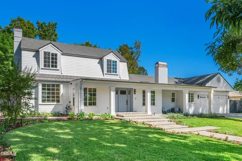 a front view of a house with a garden and porch