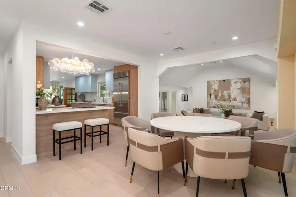 a dining room with furniture and large windows