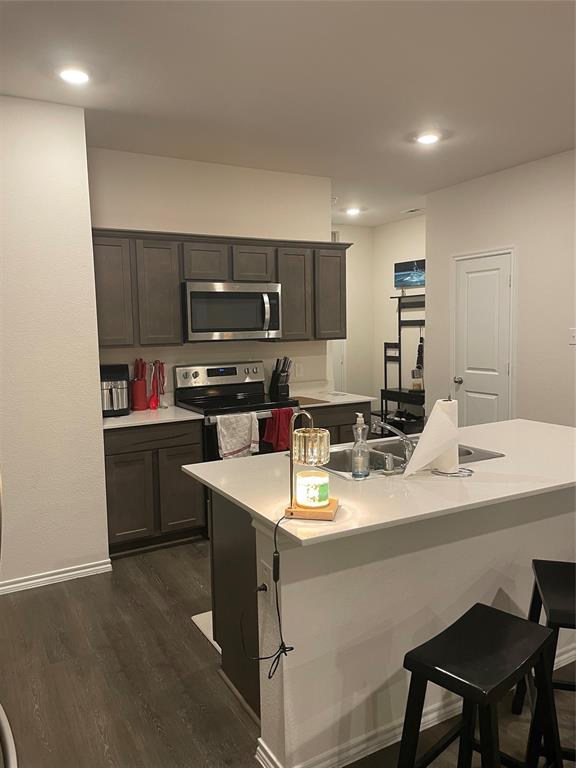 468 Unbridled Road Waxahachie, TX 75165 - Photo 3 of 10 a kitchen with a sink a stove a refrigerator and cabinets