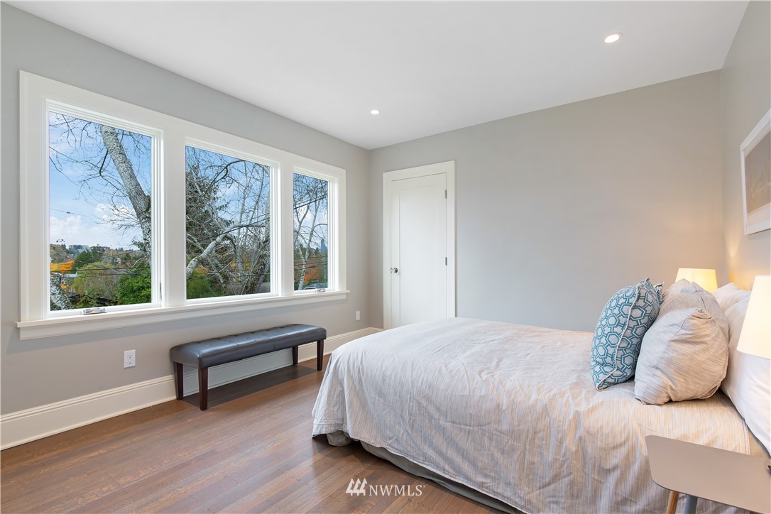 3135 37th Place South Seattle, WA 98144 - Photo 14 of 31 a bedroom with a bed and a large window