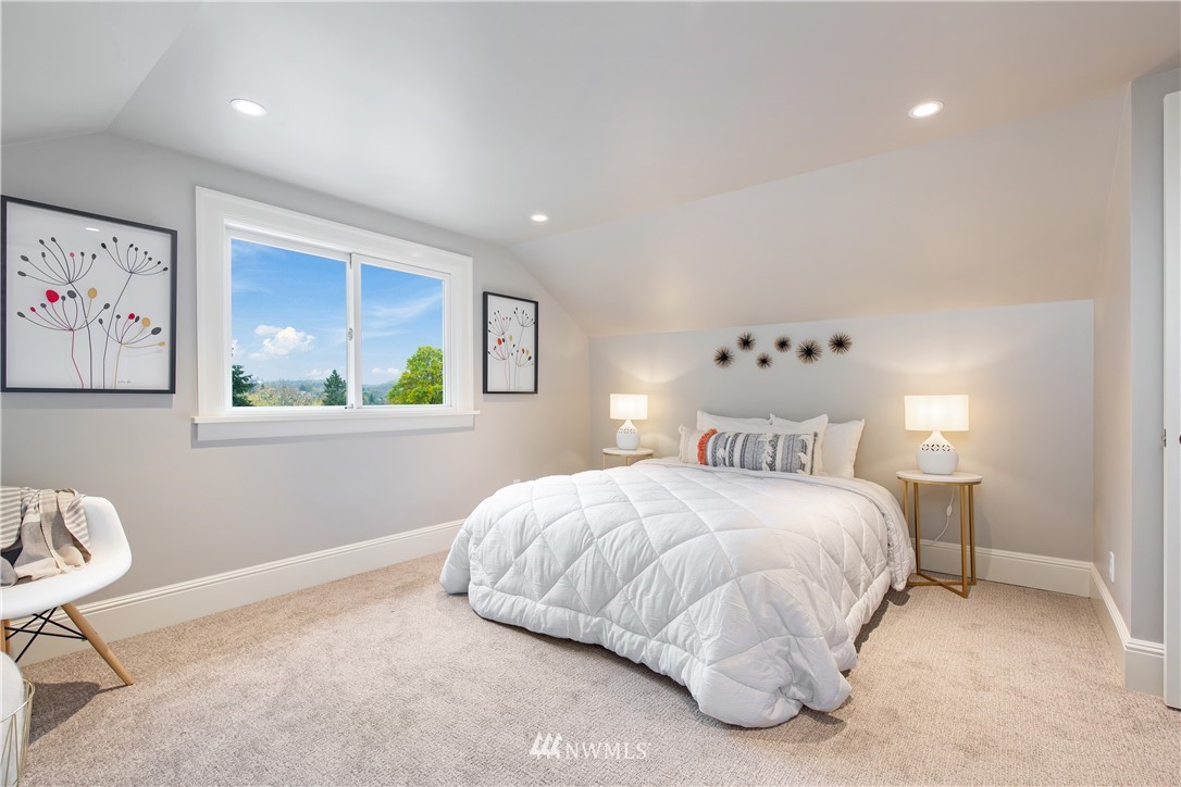 3135 37th Place South Seattle, WA 98144 - Photo 17 of 31 a bedroom with a bed and painting on the wall
