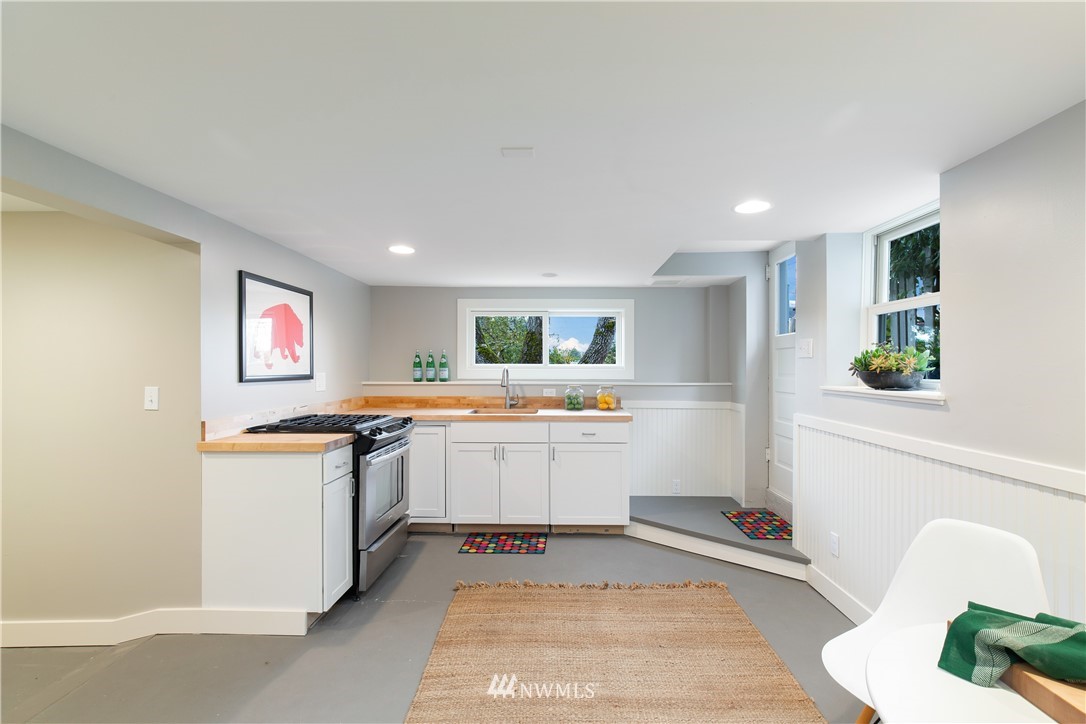 3135 37th Place South Seattle, WA 98144 - Photo 22 of 31 a open kitchen with stainless steel appliances granite countertop a stove and a sink
