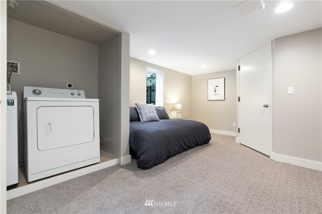 3135 37th Place South Seattle, WA 98144 - Photo 23 of 31 a bedroom with a bed and a washer dryer