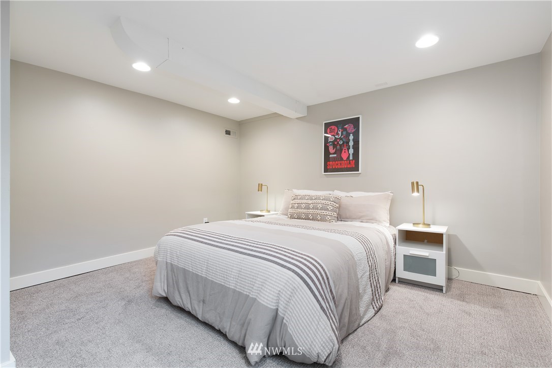 3135 37th Place South Seattle, WA 98144 - Photo 24 of 31 a bedroom with a bed and a lamp