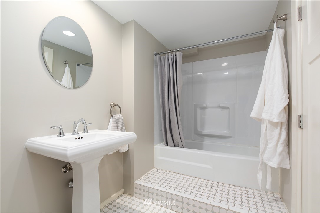 3135 37th Place South Seattle, WA 98144 - Photo 25 of 31 a bathroom with a sink a mirror and a bathtub