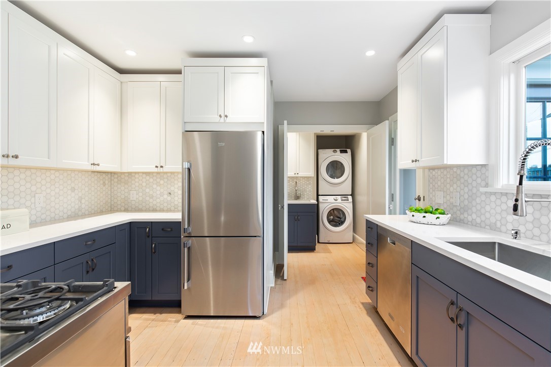3135 37th Place South Seattle, WA 98144 - Photo 6 of 31 a kitchen with stainless steel appliances granite countertop a refrigerator and a sink