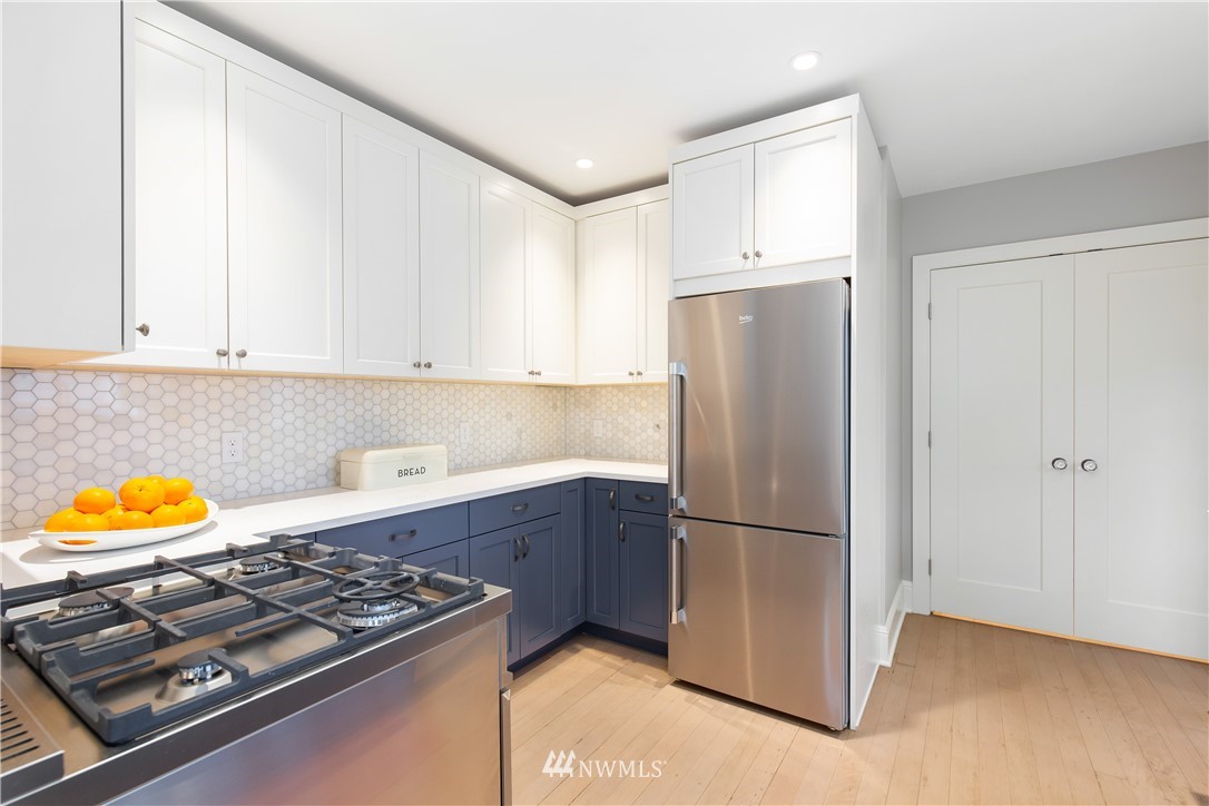 3135 37th Place South Seattle, WA 98144 - Photo 8 of 31 a kitchen with stainless steel appliances granite countertop a refrigerator and a stove