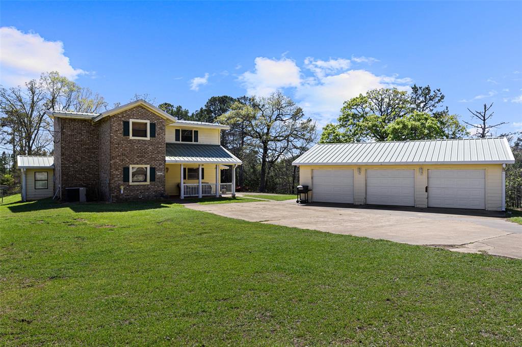 533 Huffman Road Harleton, TX 75651 - Photo 13 of 40 a front view of a house with a yard and garage