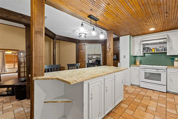 a large white kitchen with a large window