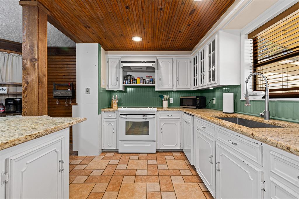 533 Huffman Road Harleton, TX 75651 - Photo 18 of 40 a kitchen with a sink stove and cabinets
