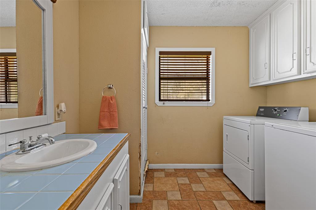 533 Huffman Road Harleton, TX 75651 - Photo 24 of 40 a bathroom with a sink a vanity and a mirror