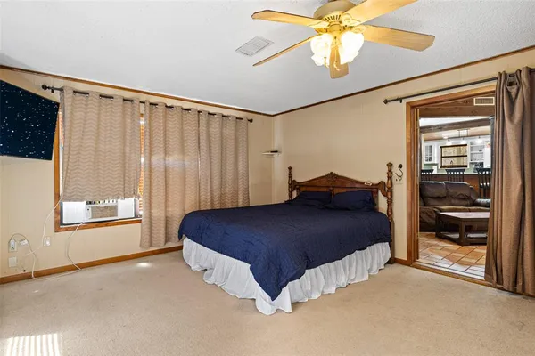a spacious bedroom with a bed and a window