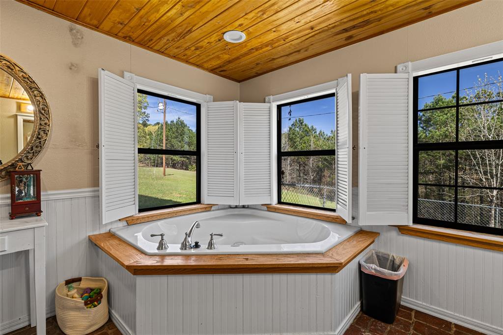 533 Huffman Road Harleton, TX 75651 - Photo 31 of 40 a bath tub sitting in front of a bathroom