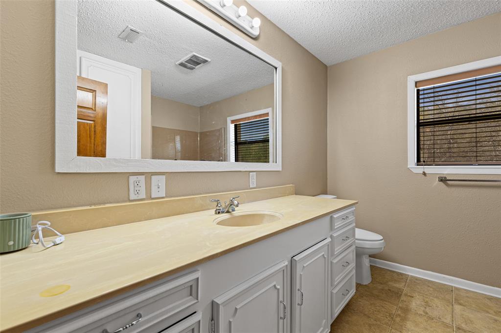 533 Huffman Road Harleton, TX 75651 - Photo 35 of 40 a bathroom with a sink and a toilet