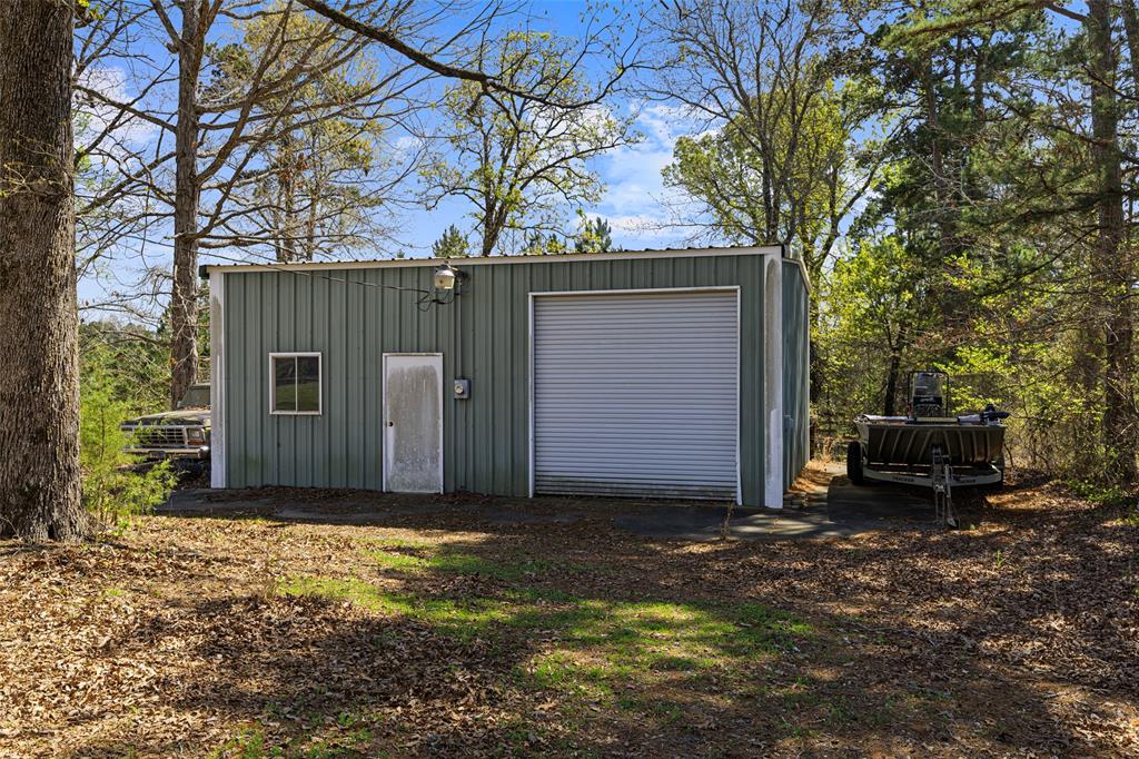 533 Huffman Road Harleton, TX 75651 - Photo 38 of 40 a view of a house with a small yard and large tree