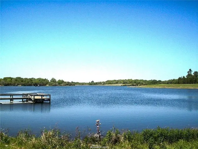 a view of a lake with a table and chairs