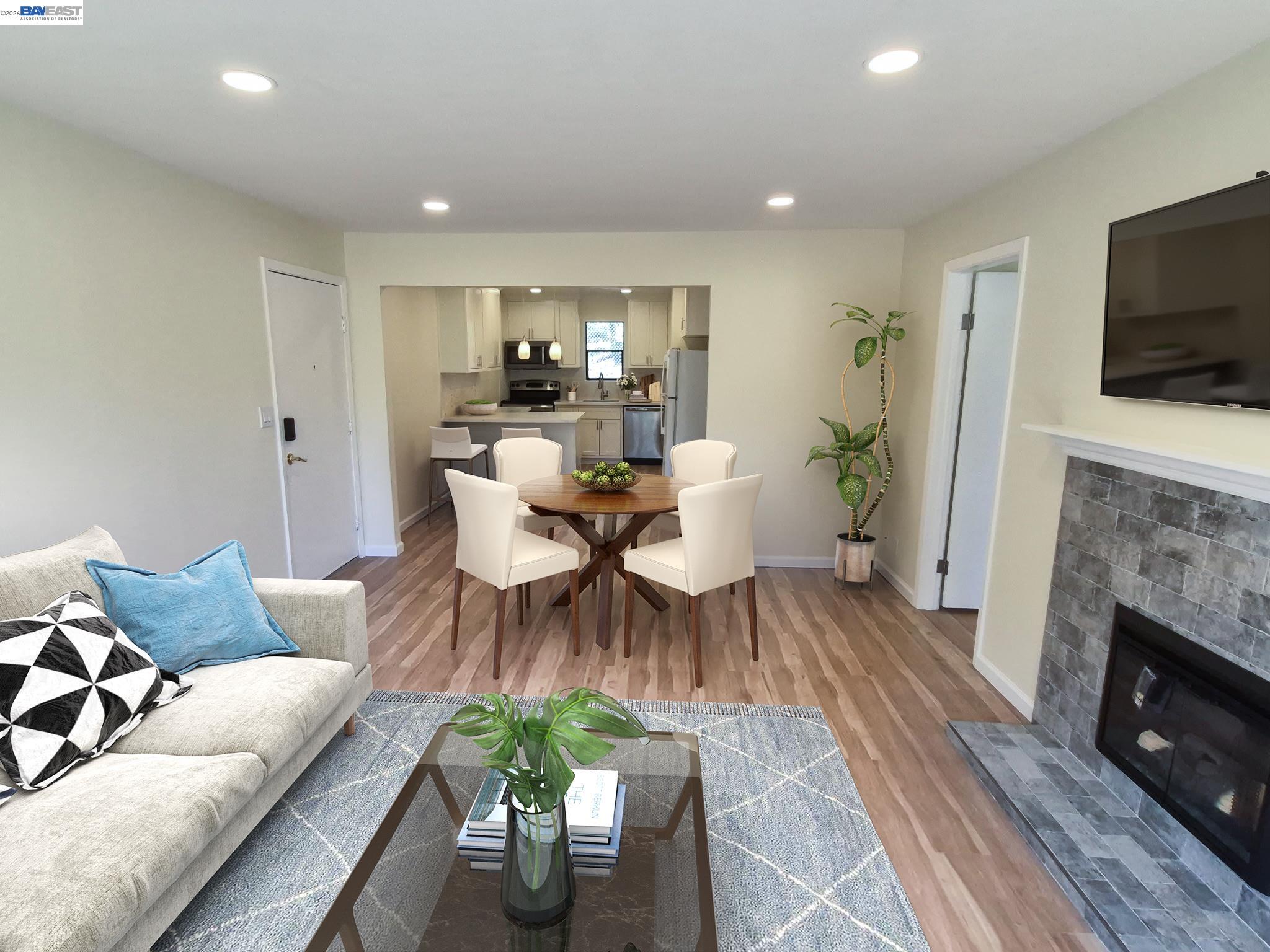 a living room with furniture a flat screen tv and a fireplace