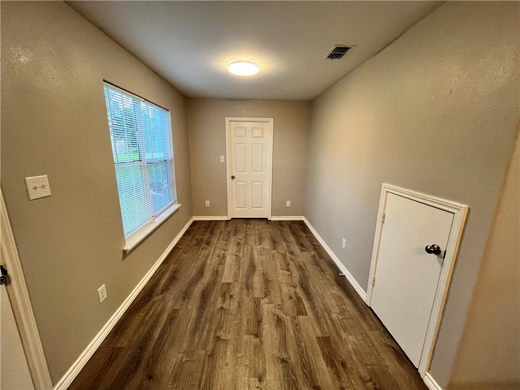 908 East Hefferman Street Beeville, TX 78102 - Photo 13 of 40 a view of a hallway with wooden floor and staircase