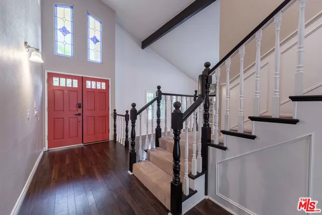 a view of entryway with wooden floor and stairs