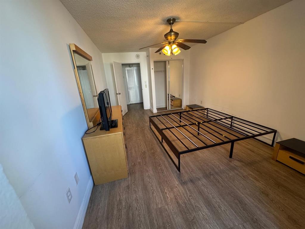 850 North Miami Avenue, Unit W703 Miami, FL 33136 - Photo 13 of 38 a living room with a bed furniture and a chandelier