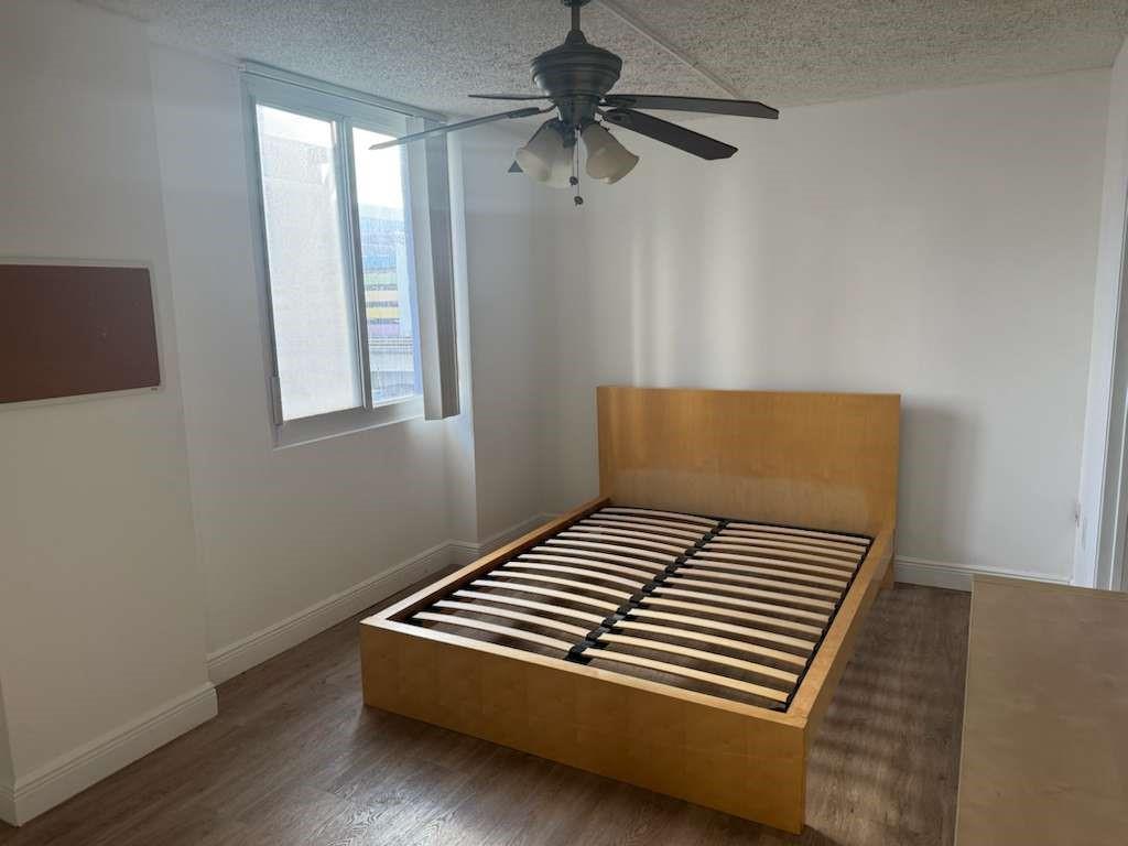 850 North Miami Avenue, Unit W703 Miami, FL 33136 - Photo 21 of 38 a bedroom with a bed and a chandelier