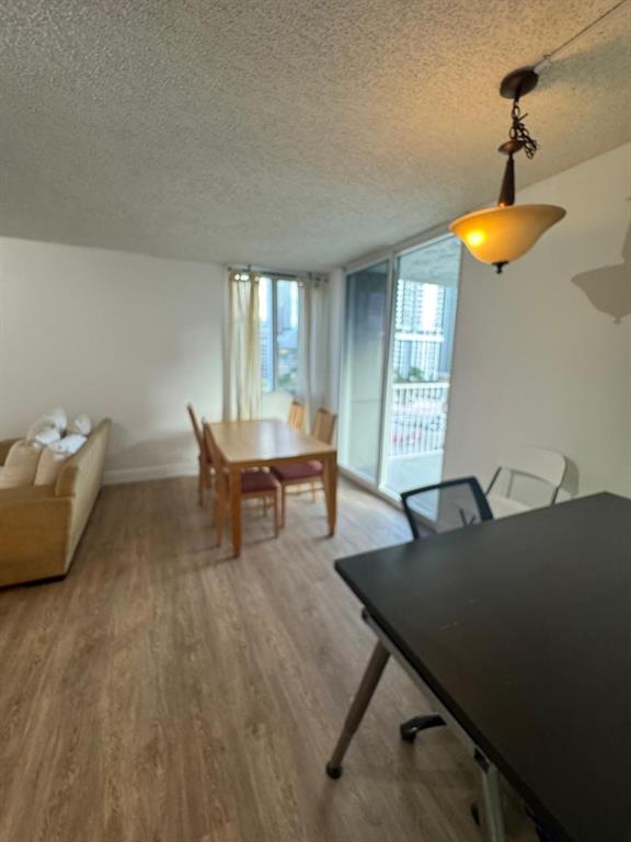 850 North Miami Avenue, Unit W703 Miami, FL 33136 - Photo 9 of 38 a living room with furniture and a chandelier