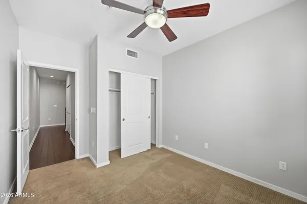 a view of a big room with closet and windows