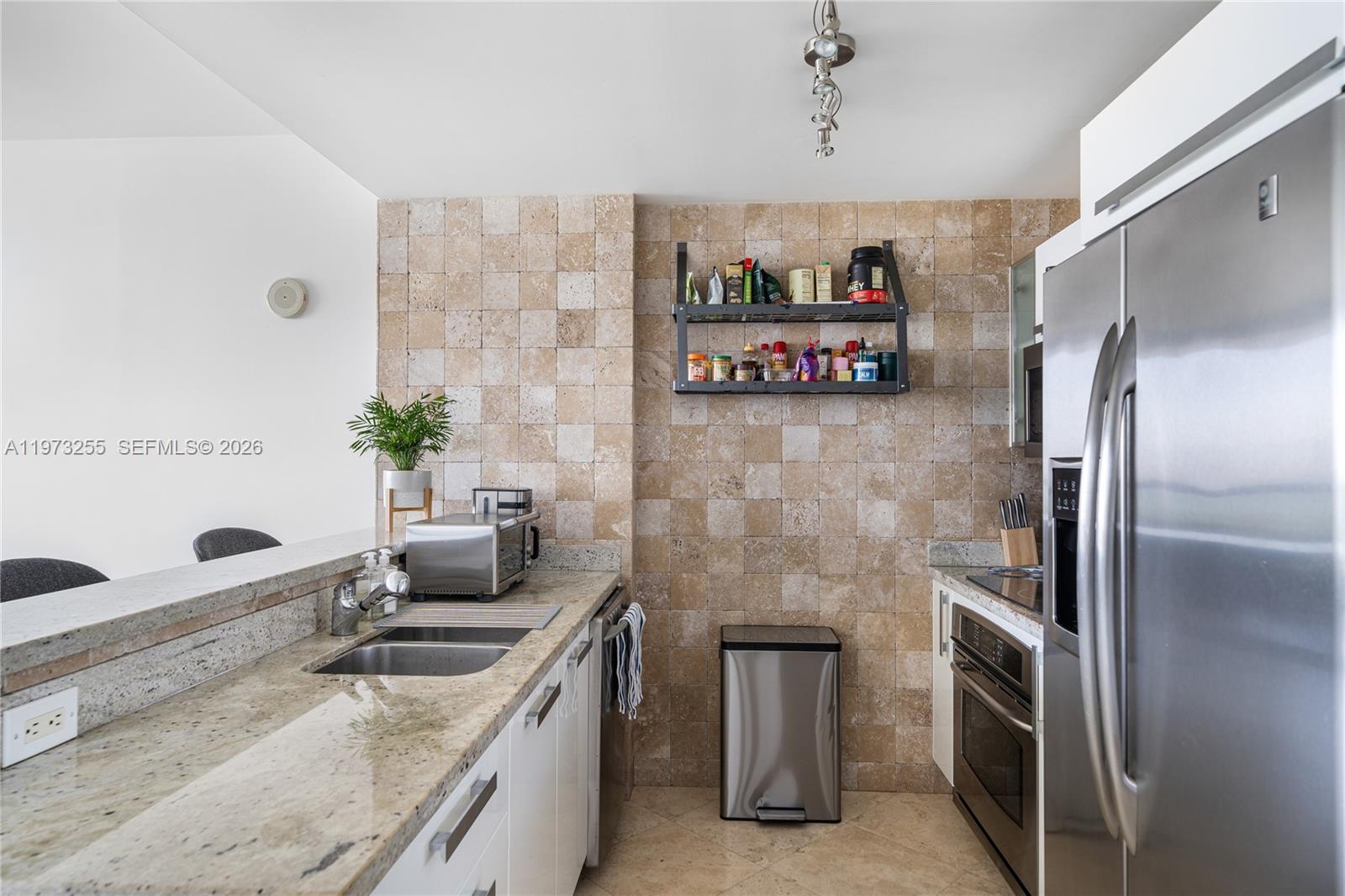 601 Northeast 36th Street, Unit 2908 Miami, FL 33137 - Photo 7 of 19 a kitchen with refrigerator and cabinets