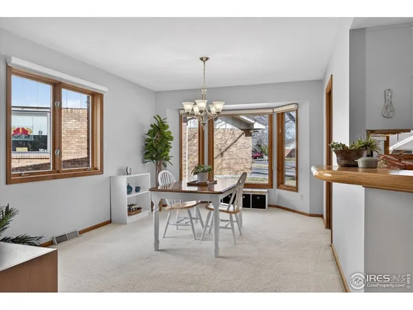 a living room with furniture a window and a dining table