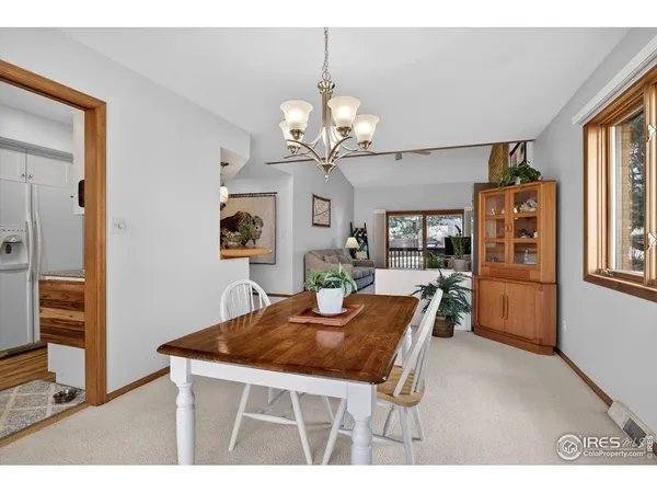 a view of a dining room with furniture and a chandelier