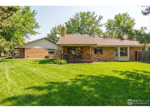 a view of a house with a yard porch and sitting area