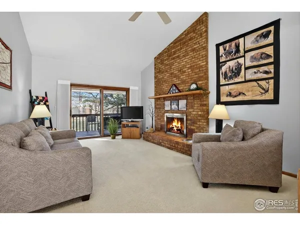 a living room with furniture large window and a flat screen tv