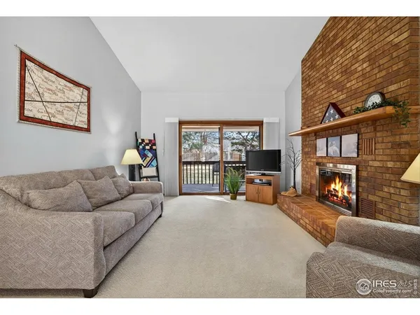a living room with furniture a ceiling fan and a rug
