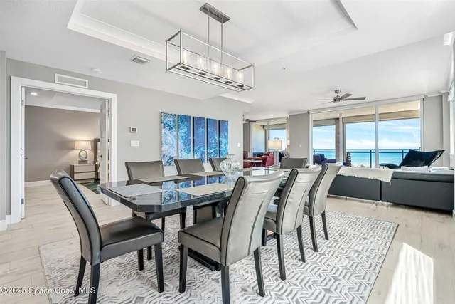 a living room with furniture ceiling fan and a window