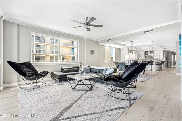 a living room with furniture and a floor to ceiling window
