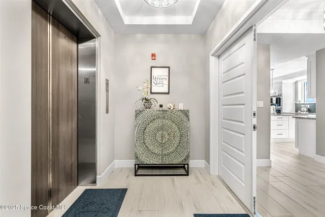 a view of a hallway view with wooden floor and windows