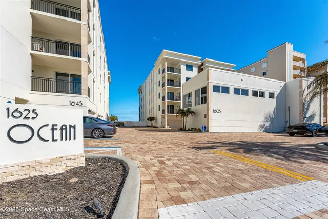 a view of a hallway with closet and wooden floor