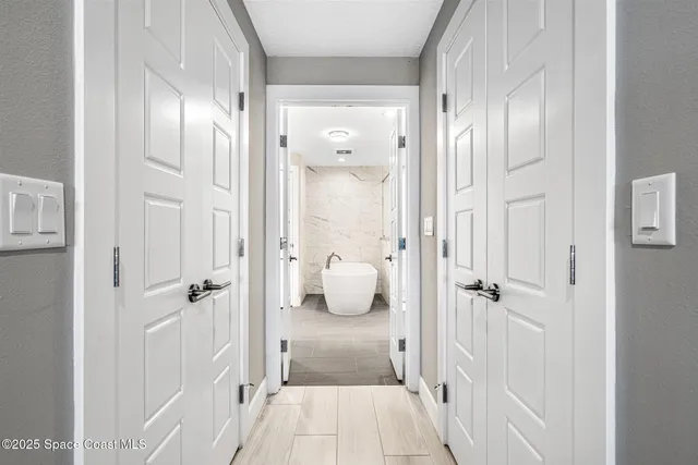 a bathroom with a granite countertop toilet a sink a mirror a window and vanity