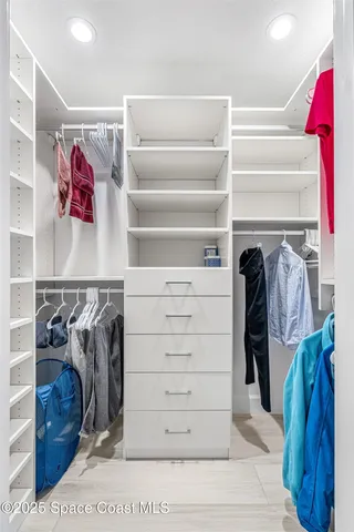 a living room with a bed furniture and a large window