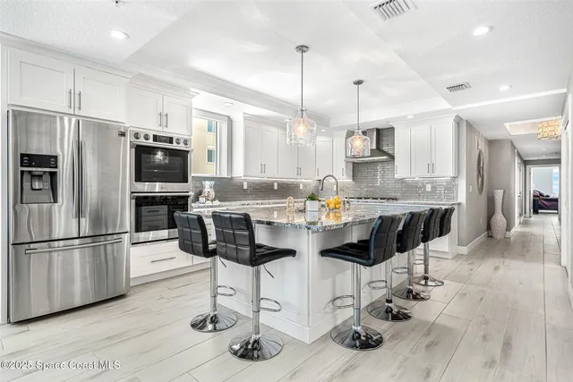 a kitchen with stainless steel appliances granite countertop a stove microwave and cabinets