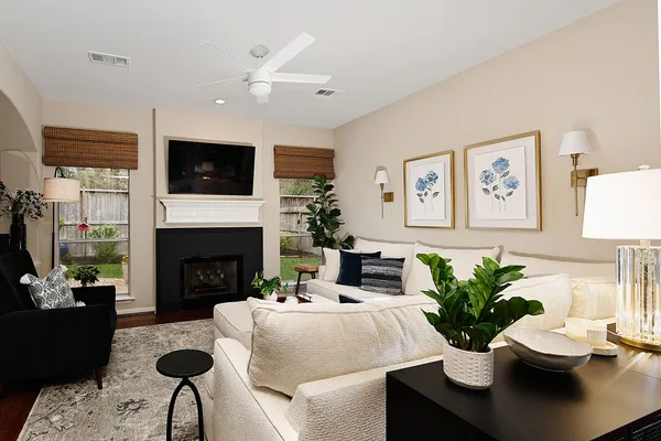 a living room with furniture potted plant and a fireplace
