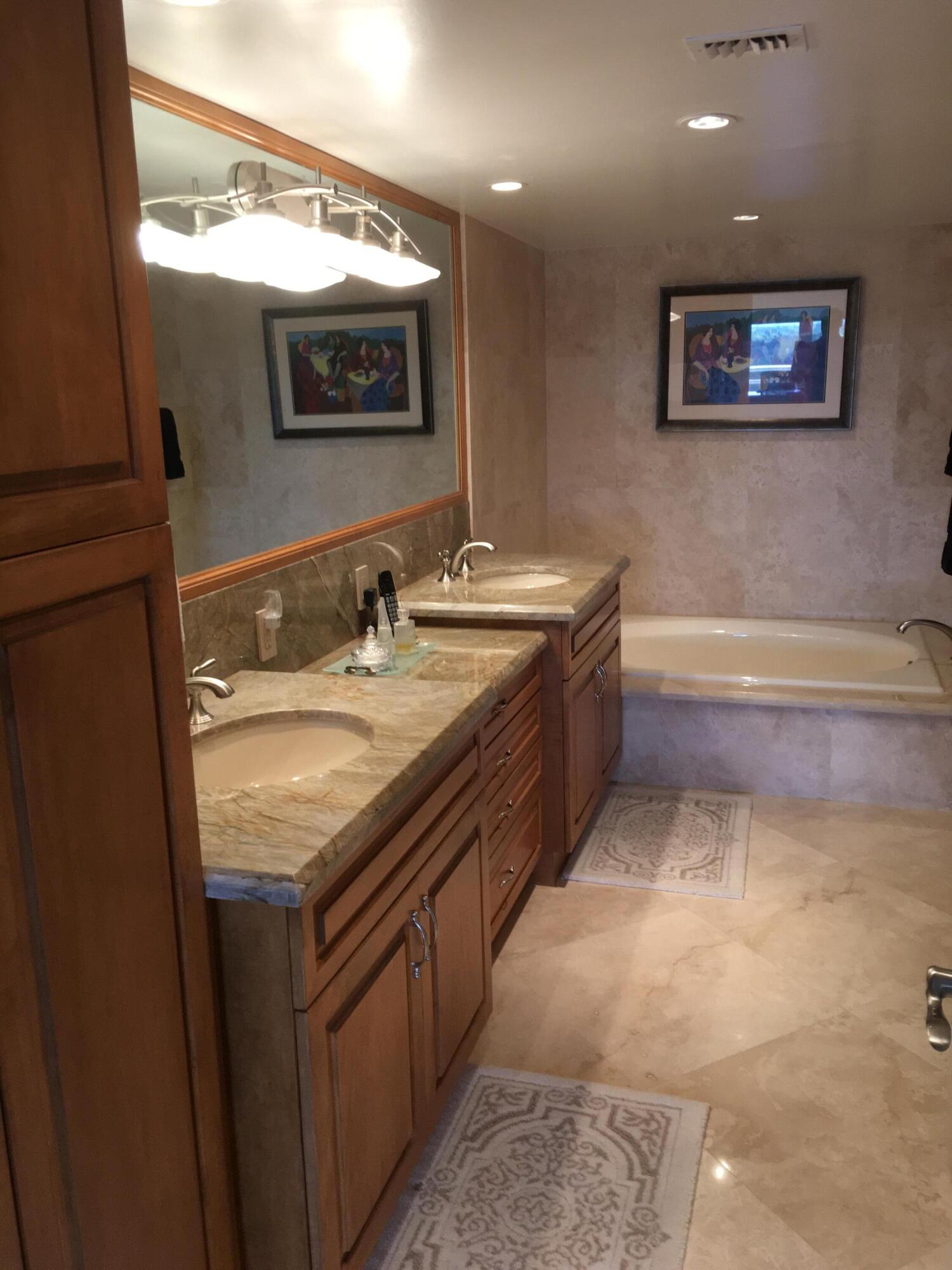 4101 North Ocean Boulevard, Unit 703 Boca Raton, FL 33431 - Photo 12 of 31 a bathroom with a granite countertop sink and a mirror