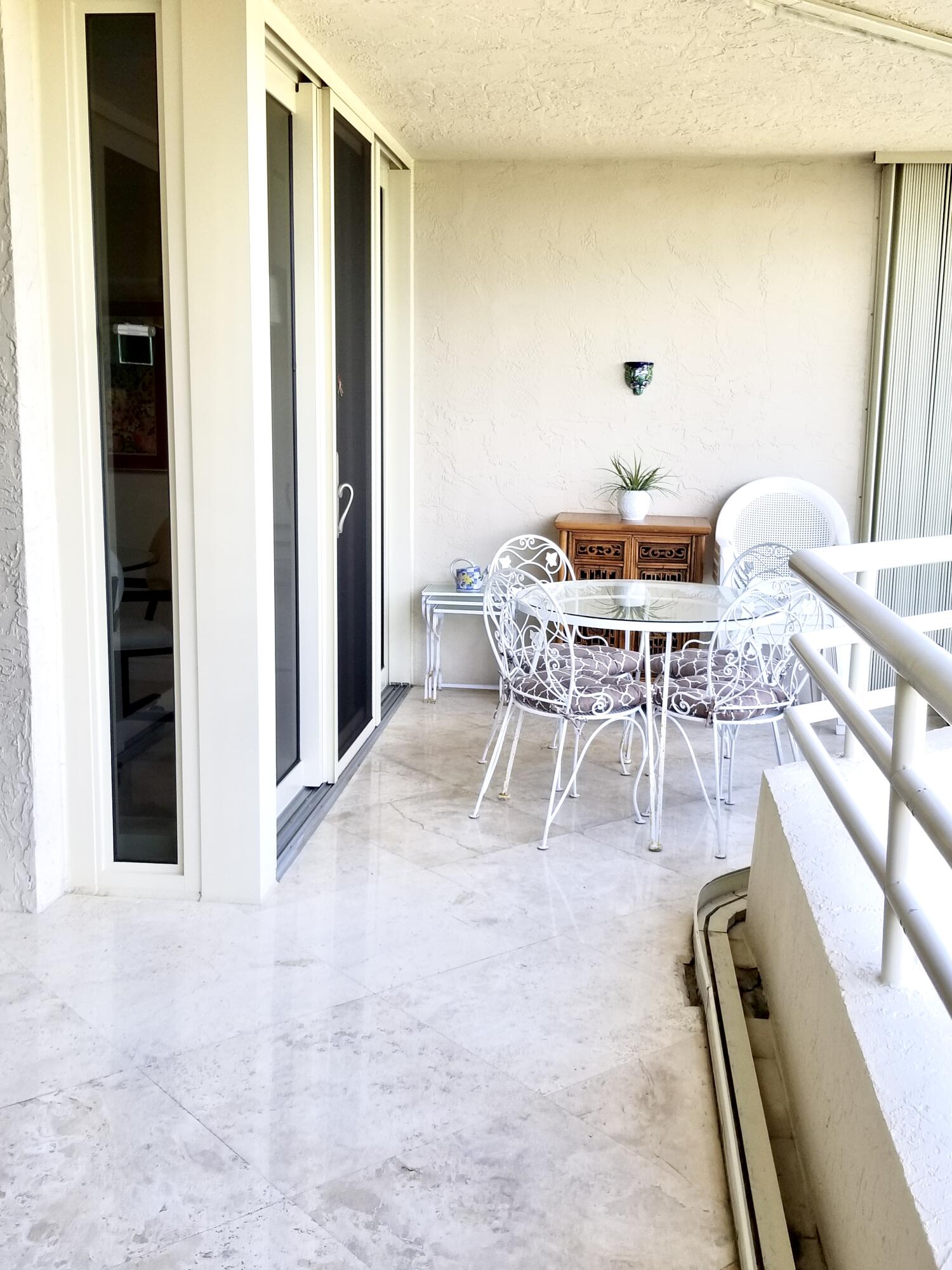 4101 North Ocean Boulevard, Unit 703 Boca Raton, FL 33431 - Photo 9 of 31 a dining room with furniture and a rug