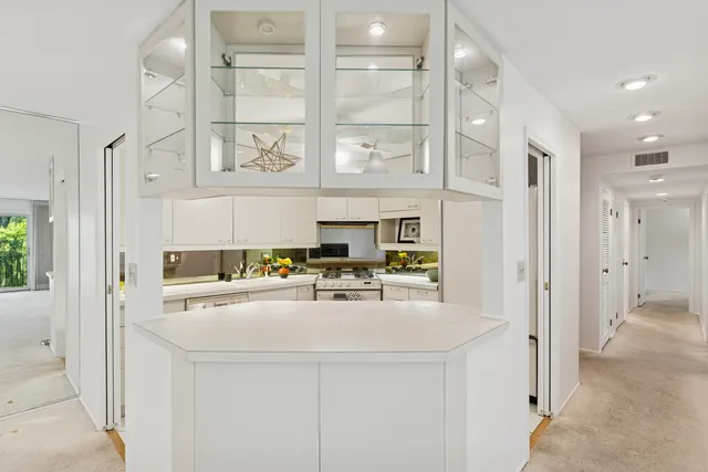 a kitchen with stainless steel appliances a white cabinets stove and a refrigerator