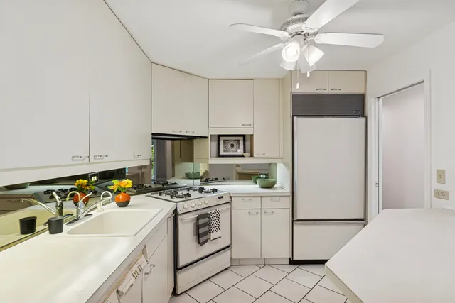 a kitchen that has a cabinets and white appliances