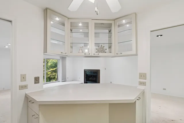 a room with windows and ceiling fan