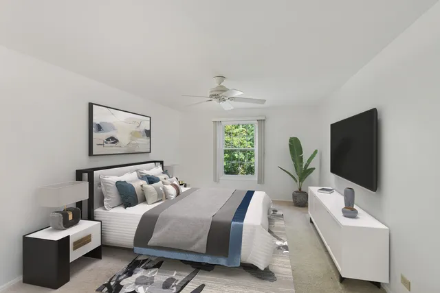 a bedroom with furniture and a flat screen tv